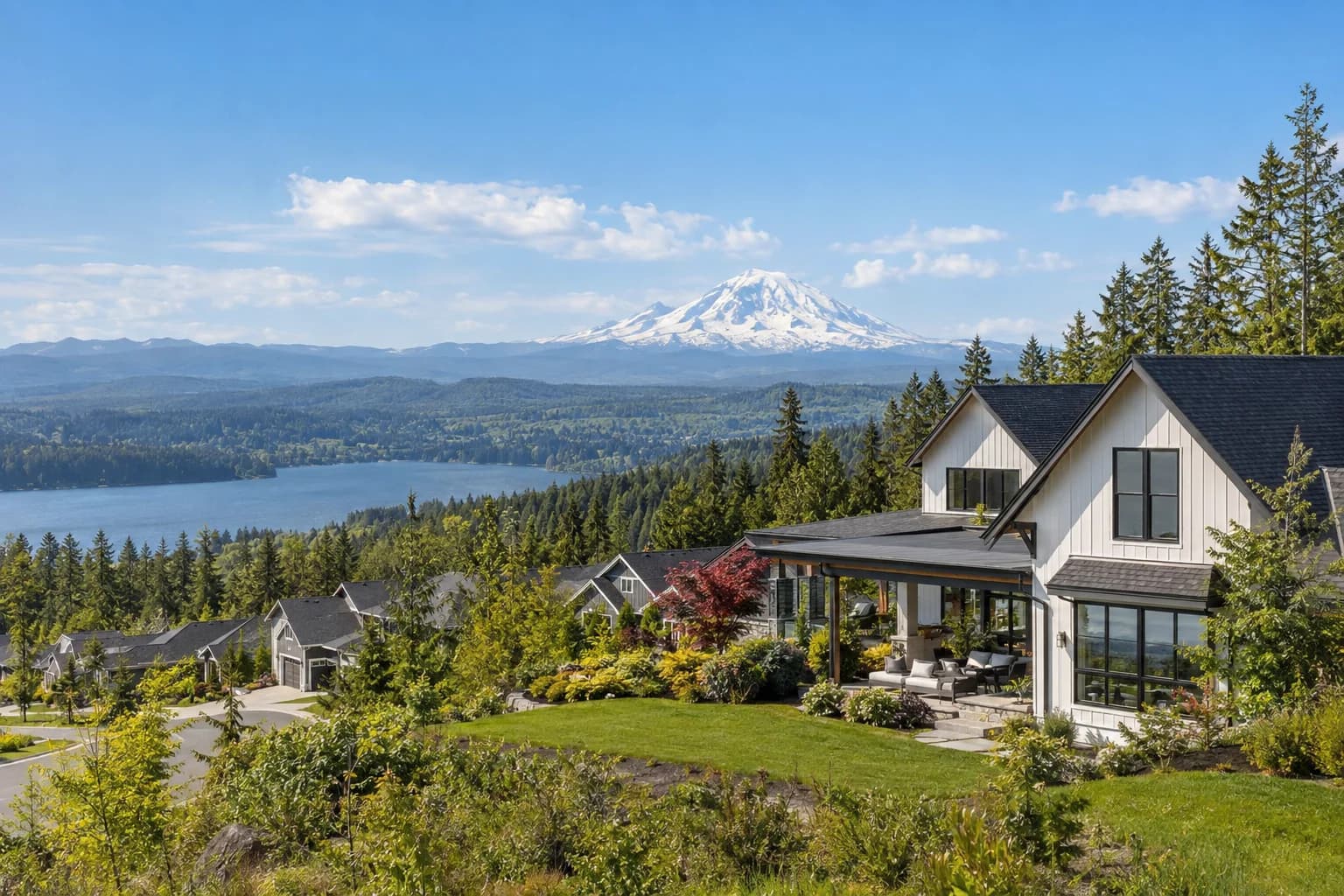 New-construction modern farmhouse with black-framed windows in Black Diamond, Washington, with a master-planned community at the forest edge with Mount Rainier on the horizon