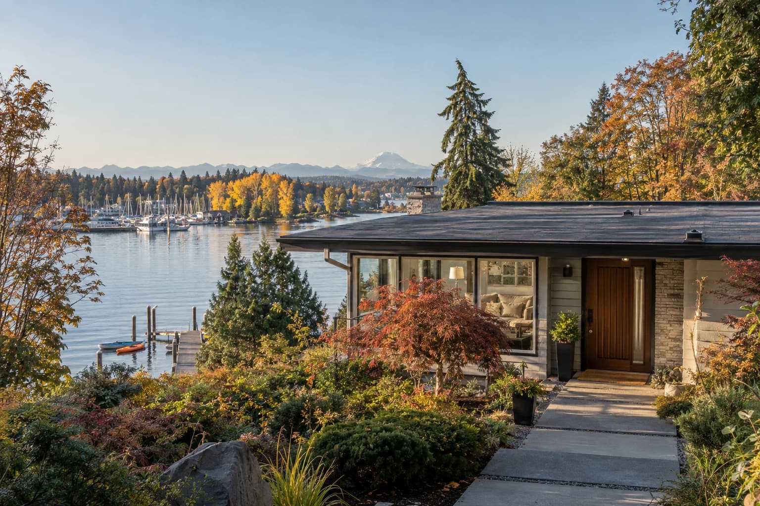 Updated 1960s rambler with a big picture window and a dock in Kenmore, Washington, with the north end of Lake Washington near the Sammamish River mouth, kayaks and marina masts