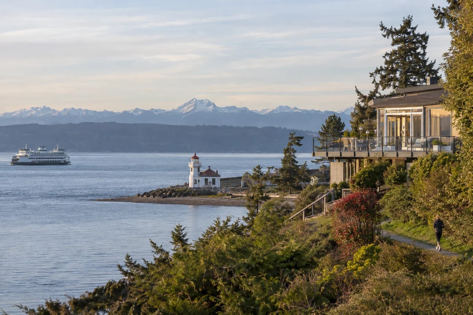 Bluff home with a glass-railed deck over the Sound in Mukilteo, Washington, with the Mukilteo Lighthouse, the Whidbey Island ferry, Puget Sound and the Olympic Mountains
