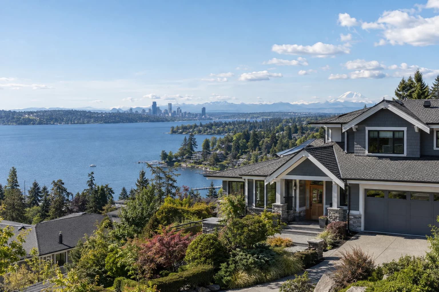 Updated craftsman on a lakeview slope in Renton, Washington, with the Kennydale shore of Lake Washington with the Seattle skyline far across the water and the Cascades behind
