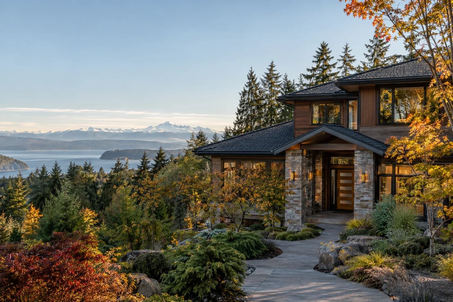 Newer two-story home with a deep back deck in Snohomish County, Washington, with a large lot at the forest edge with the snow-capped Cascade Mountains