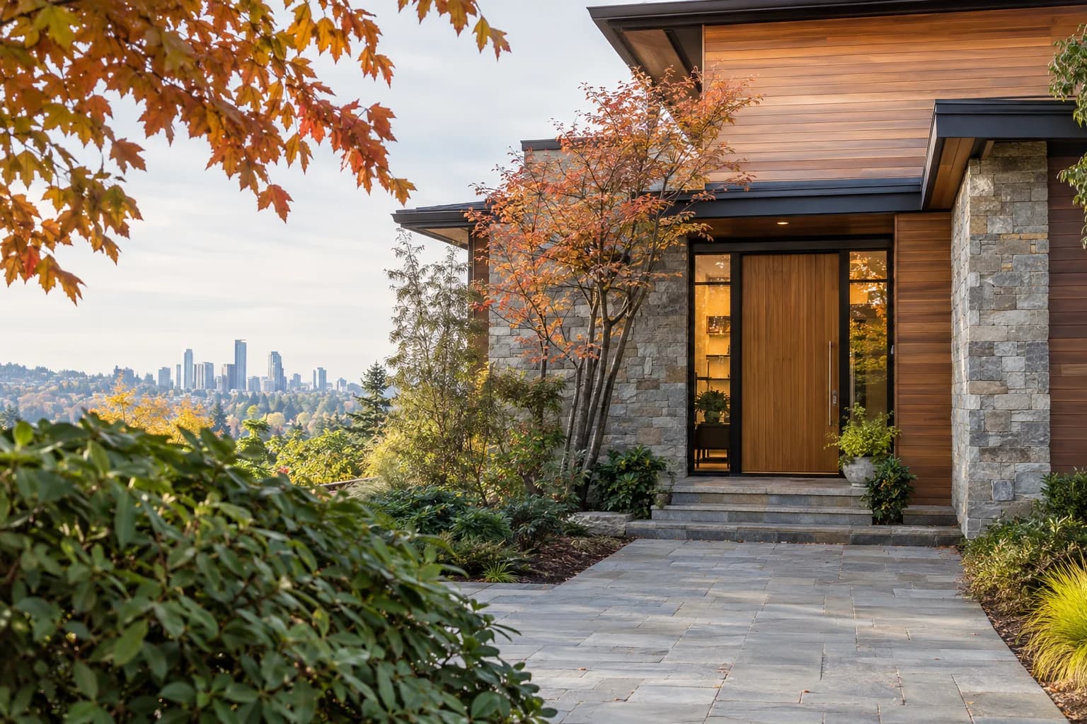 Crisp autumn driveway approach to a modern Northwest home, stone path and cedar siding in Bellevue — RexMont Real Estate
