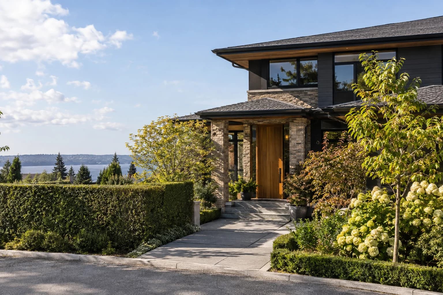 Quiet affluent residential street with a refined front entry and mature hedges in Seattle — RexMont Real Estate