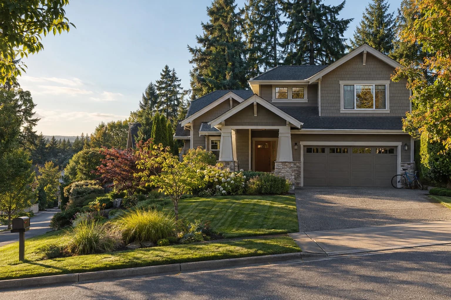 Craftsman single-family home in Redmond with a two-car garage, mowed lawn and Douglas firs in golden afternoon light — RexMont Real Estate