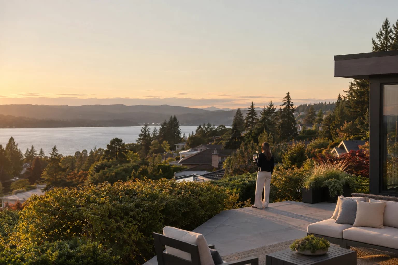 Regional Eastside neighborhood establishing shot with evergreen hills and residential rooftops — RexMont Real Estate